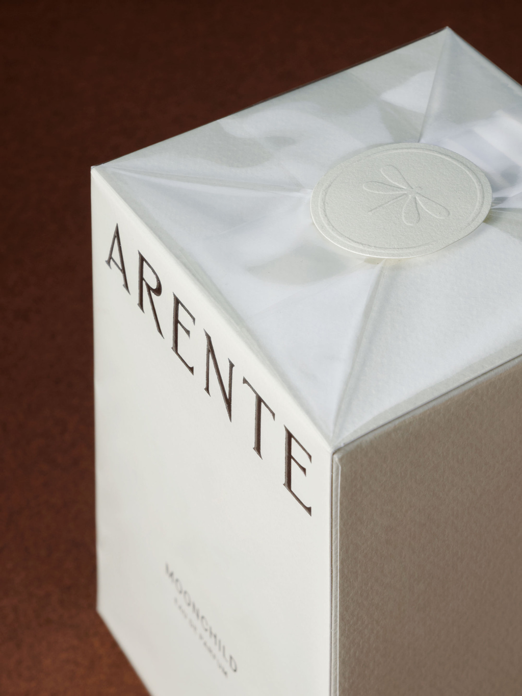 Packaging wrapped in plastic and sealed with a blind embossed sticker