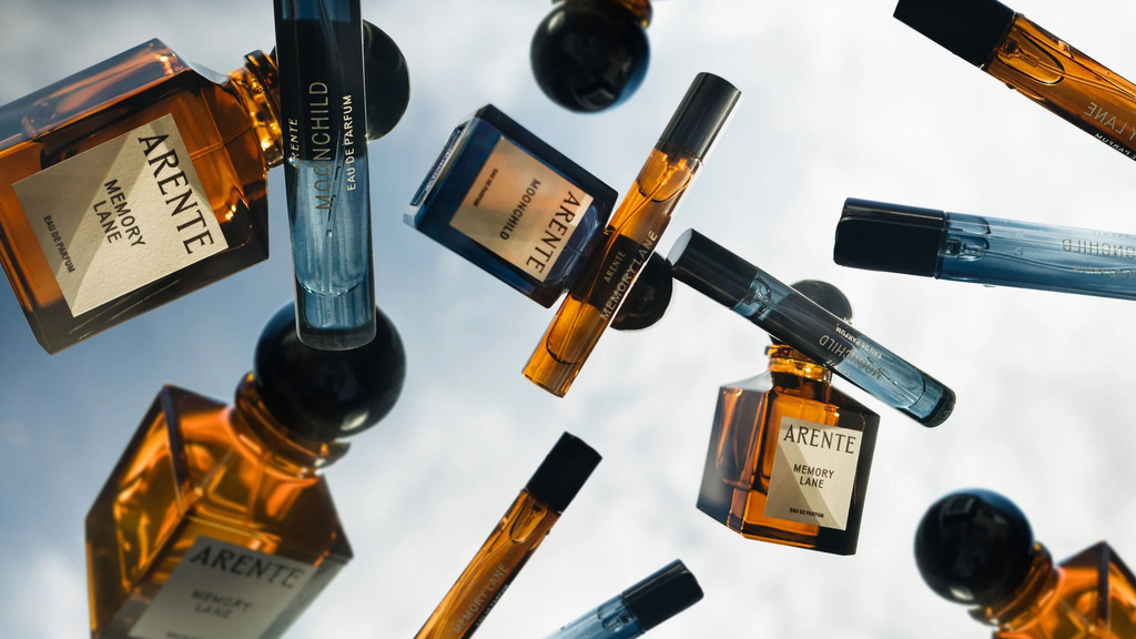 Brown and blue perfume bottled flying in the air with cloudy sky in the background