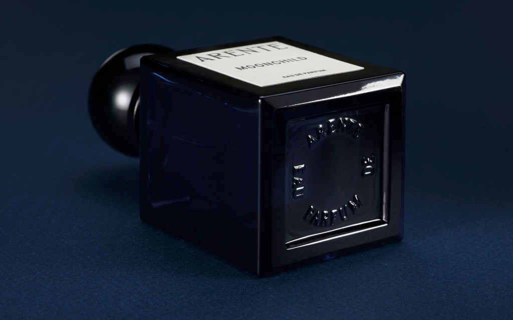 Bottom of perfume bottle with embossed typography
