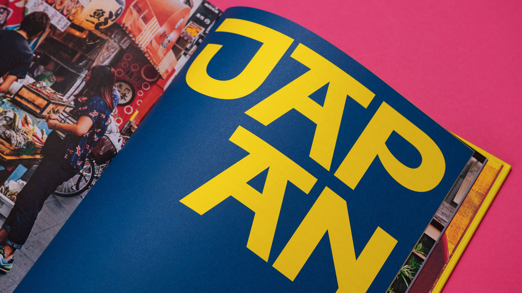 Open book with page sayin "Japan" in bold yellow typography