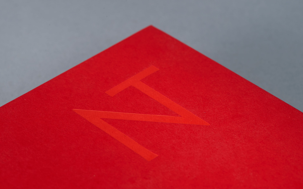 NT-symbol on red bible.