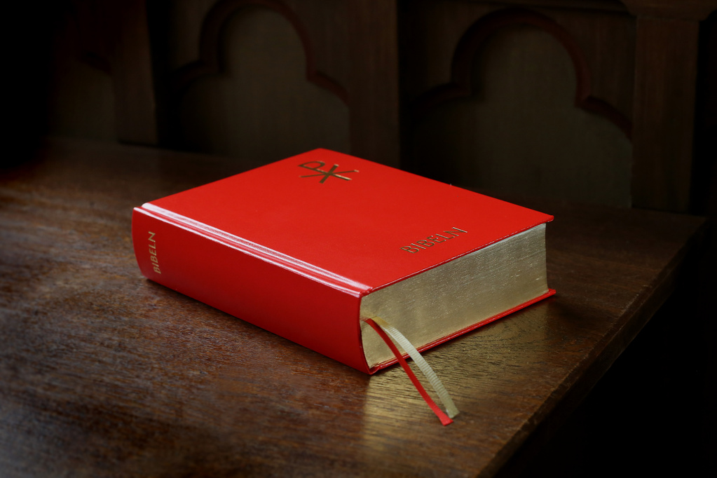 The Bible, red edition with gilt edges.